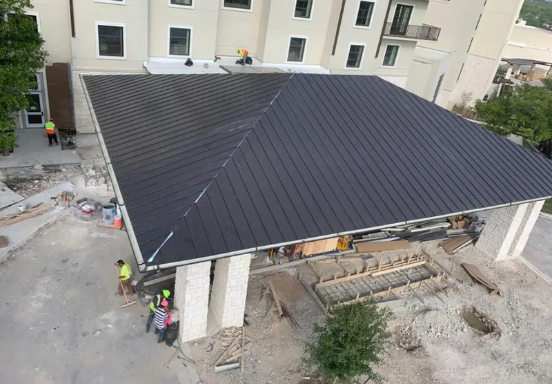 Metal roofing installation team working on a commercial building in Gainesville